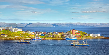 View of Honningsvag Nordkapp Norway showing colorful waterfront houses blue sea and arctic hills