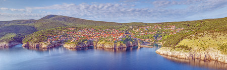 Aerial view of Vrbnik village with red rooftops on cliffs above Adriatic sea Krk island Croatia
