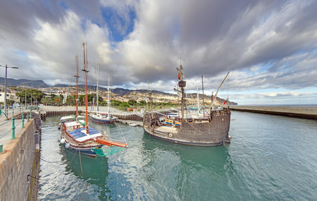 Panoramic view over Porto Moniz harbor with cliffs and Atlantic Ocean on Madeira island under bright blue sky.の写真素材
