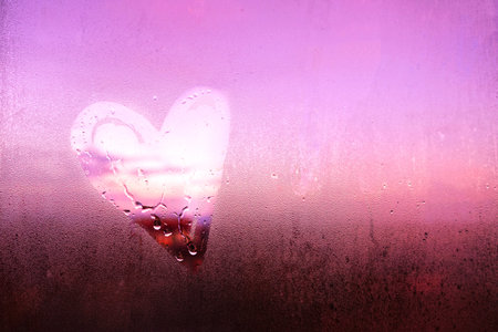 Heart shape on fogged window glass. Love conceptの写真素材