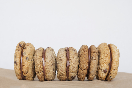 Tasty hazelnut and almond sandwich biscuits with chocolate, ganache and gianduja filling. Baci di dama or Ladys kisses are italian cookies from Piedmont. copy spaceの写真素材