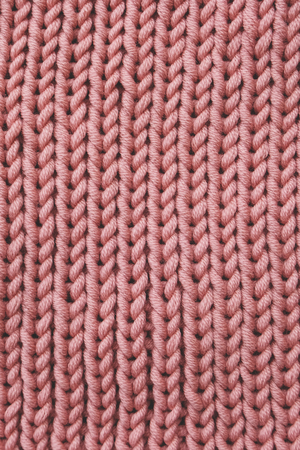 Soft pastel pink knitted texture for background. Merino yarn. Living coral colour trend of the year 2019の写真素材