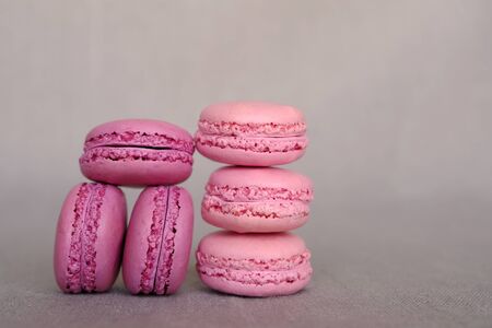 Stack of delicious french strawberry and blueberry flavour macarons on grey background. Sweet food. Copy space. Confectioneryの写真素材
