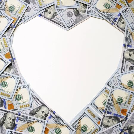 Heart shape made of hundred dollar bills on white background. Space for text. Heap of usd, american cash money. Love for money.の写真素材