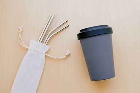 Reusable plastic free and eco friendly utensils. Stylish metal drinking straws, bamboo coffee cup.の写真素材