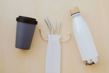 Reusable plastic free eco friendly utensils. Metal drinking straws, bamboo coffee cup, water bottle.の写真素材
