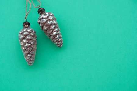 Lovely vintage Christmas decorations in the shape of pine cones on trendy neo mint background.の写真素材