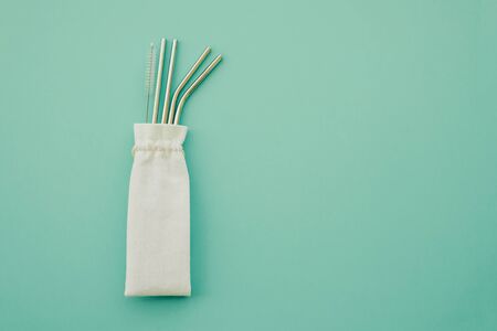 Reusable eco friendly sustainable stainless steel metal straws on mint background.の写真素材