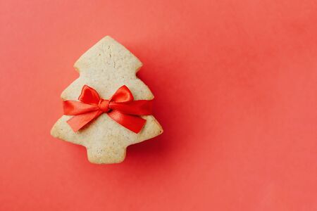 Stack of shortbread cookies in the shape of Christmas tree tied with red ribbon.の写真素材