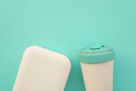 Reusable stylish eco friendly bamboo cup and lunch box on light blue background.の写真素材