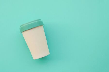 Reusable stylish eco friendly bamboo cup on light blue background.の写真素材