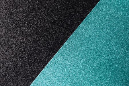 Bicolor geometric light blue and black glittery background with space for text. Shining sparkly festive holiday backdrop for your design. Flat lay. Copy space.の写真素材