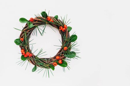 Pretty eco friendly Christmas wreath made of natural materials on white woodenの写真素材