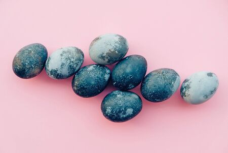 Natural dyed blue colored eggs on pastel pink background, top view. Flat lay. Happy Easter.の写真素材