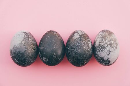 Natural dyed grey and white colored eggs on pastel pink background.の写真素材