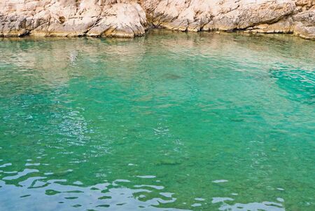 Beautiful wild beach with turquoise water and rocky cliffs in Calanques National Park.の写真素材