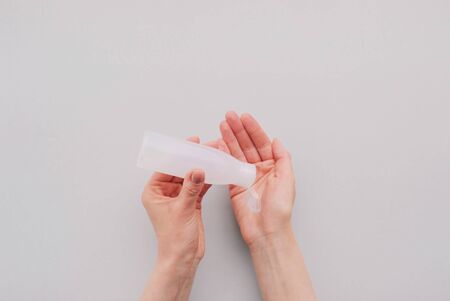 Disinfecting hands using sanitaser antiseptic gel, close up.の写真素材