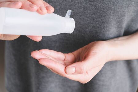 Woman disinfecting hands using sanitaser antiseptic gel.の写真素材