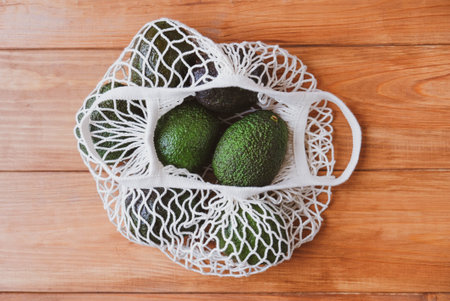Reusable eco-friendly cotton mesh bag with avocado.