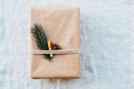 Wrapping gifts with natual decorations such as fir branch, cinnamon sticks, star anise. Zero waste Christmas concept. Plastic free holidays. Sustainable lifestyle.の写真素材