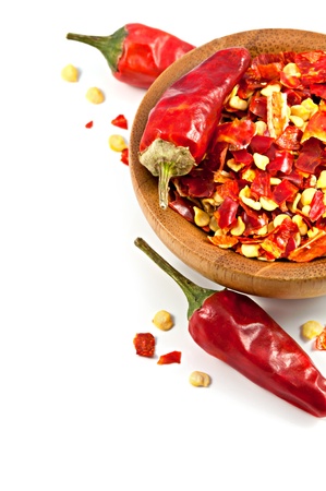 Wooden bowl with dried crushed chili red pepper isolatedの写真素材