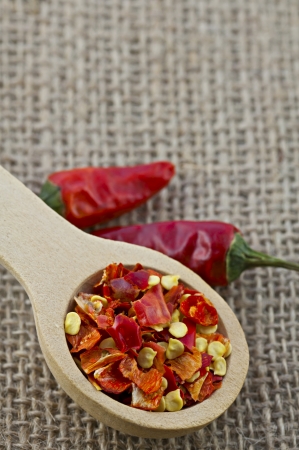 Wooden spoon with dried crushed chili red pepperの写真素材