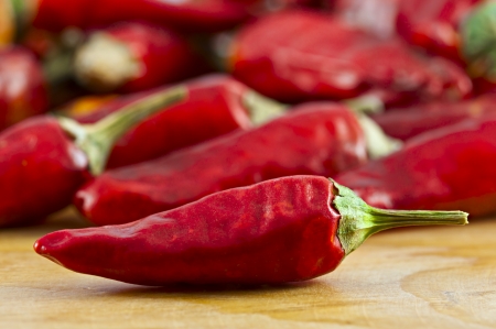 Dried cayenne red pepper on wooden surface selective focusの写真素材