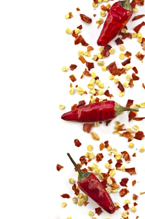 Dried crushed chili red pepper and whole dried chili peppers isolated on white background  Oriental spicy food concept の写真素材
