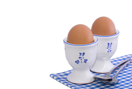 Healthy breakfast set with two soft boiled eggs isolated on whiteの写真素材