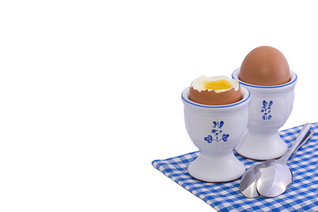 Healthy breakfast set with two soft boiled eggs isolated on whiteの写真素材