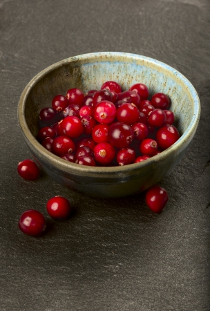 Bowl full of fresh ripe cranberries の写真素材