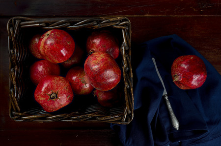 Kitchen table with fruits of pomegranateの写真素材