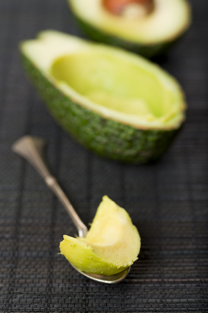 Avocado on a black tableclothの写真素材