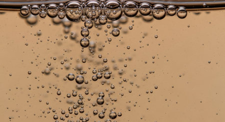 A mesmerizing close-up of bubbles rising in a liquid, showcasing the beauty of effervescence and the intricate textures created by the gas-liquid interaction.の素材