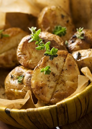 cruncy golden  potatoes, straight from the oven, sprinkled with fresh oregano fresh の写真素材