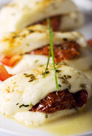 cypriot halloumi cheese baked with garlic,herbs,sundried tomatos and red pepperの写真素材
