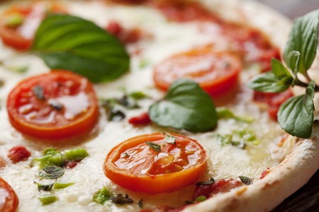 fresh italian pizza, with tomato, mozzarella and green pepperの写真素材