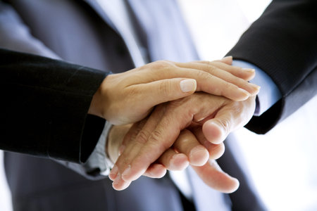 stacked hands, symbolising team-effort
