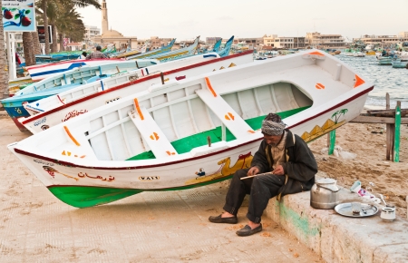 Old egyptian craftsman making the wooden boat repairのeditorial素材