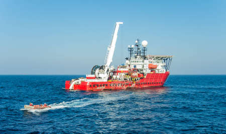 Dynamically positioned diving support vessel lunched inflatable boat with a diversの写真素材