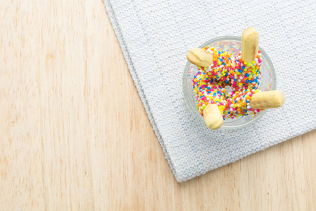 Sweet bread sticks with chocolate and colorful sugar sprinkles.の写真素材