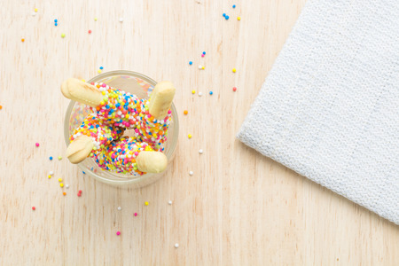 Sweet bread sticks with chocolate and colorful sugar sprinkles.の写真素材