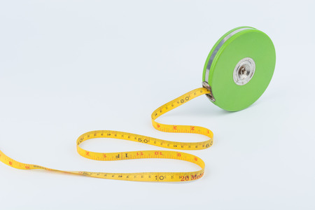 Green measuring tape for long distance measurement on white backgroundの写真素材