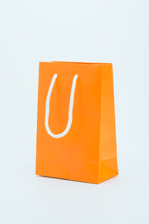 Orang paper shopping bag on a white backgroundの写真素材