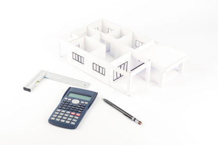 Model of the house and  calculator, pencil, Plastic right angle on white background