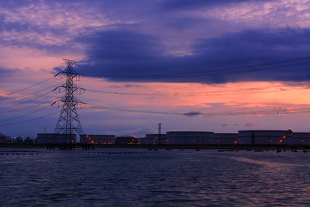 Industrial plants located by the sea with beautiful twilight sky background.の写真素材