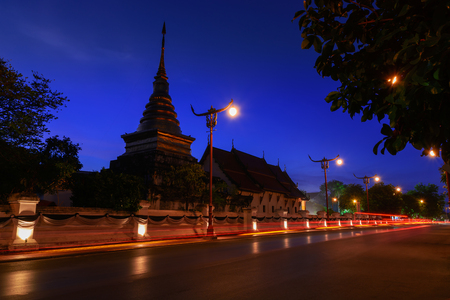 Wat Phrathat Chang Kham Worawihan in twilight scene with light trails from long exposure.のeditorial素材