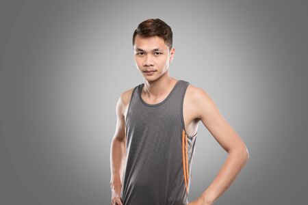 Asian men aged 20-30 years in gray sports suit  on gray background.の写真素材