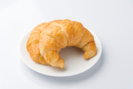 2 Delicious croissants on a white plate on a white background.の写真素材