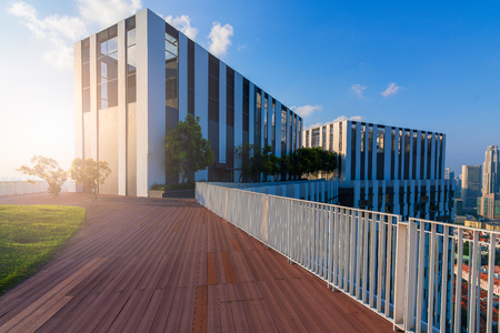 Condo with wooden walkout deck and garden on background blue sky at the city.の写真素材